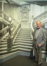 My husband, Paul Lalli, in front of a photo of the grand staircase of the <i>Olympic</i>, sister ship of the <i>Titanic</i> — Maritime Museum of the Atlantic, Halifax. Photos by Julie Skurdenis