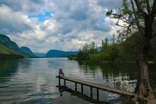 Our friend Brenda sitting on a pier on one of the many lakes we visited.