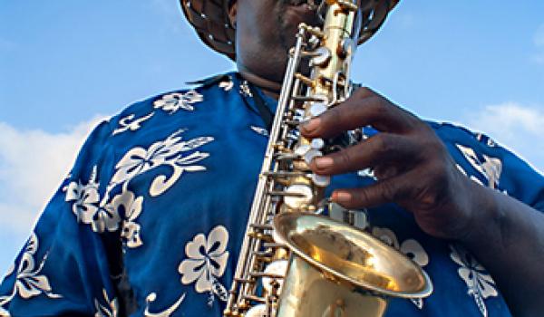 Musician playing the saxophone near the port of Nassau, New Providence Island, The Bahamas, Caribbean.