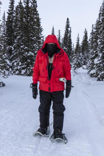 Steve, all bundled up, tests his skill on snowshoes.