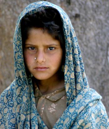 A shepherd girl poses for a photo.