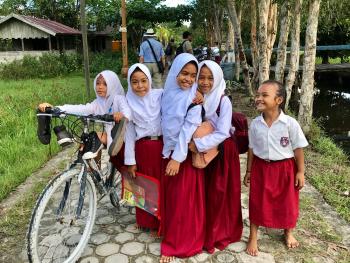 Shy, giggly schoolgirls stopped for a photo in Pangkalan Bun, Borneo.