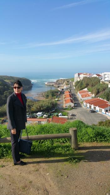 Gail Keck, with Porto Côvo’s tiny harbor in the background.