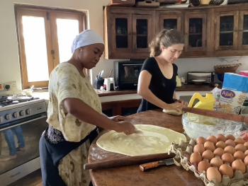 Rehema teaching Allison how to make <i>chapati</i>.