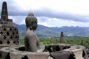 Buddha statue inside a stupa at Borobudur (UNESCO Site No. 592) — Java, Indonesia.