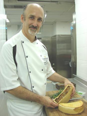 Chef Stefan Hogan with the rabbit pie sliced in half.