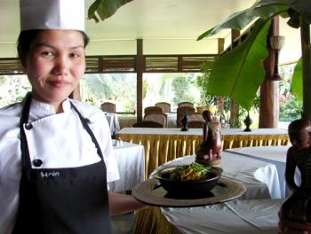 Chef Myint Oo and a bowl of the Rakhine Hot and Spicy Chicken Curry with garnish. Photos by Sandra Scott