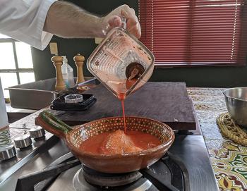 Pouring marinade over the fish.