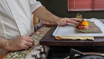 Wrapping the fish in the banana leaf.