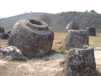 A few of the ancient stone jars in the Plain of Jars — Laos.