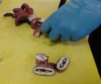 Cutting the octopus into pieces. 
