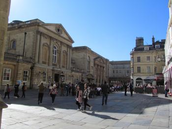 Entrance to the Roman baths (building to the left) in Abbey Churchyard, Bath, England.