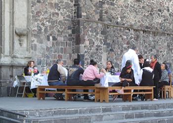 Parishioners gathered for breakfast on a Sunday morning outside the side entrance of the Templo de Santiago — Mexico City.