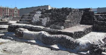 Stone serpent at the base of a pyramid at Templo Mayor.