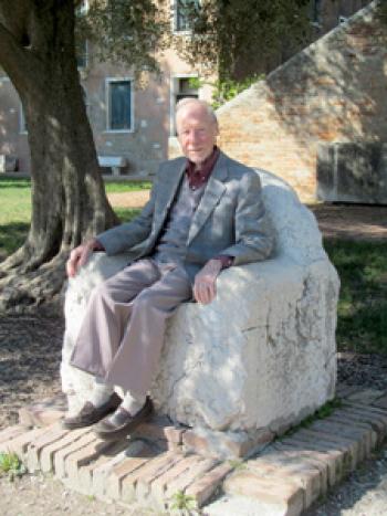 Julie Skurdenis’ husband, Paul Lalli, sitting on Attila’s Throne — near the Church of Santa Fosca, Torcello island.