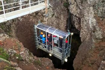 A lift lowers visitors on the “Inside the Volcano” tour 400 feet down into a vast, colorful chamber in the dormant Þríhnúkagígur volcano. Photo by Glenn Eriksen