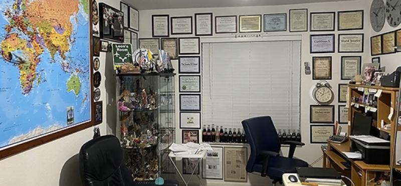 Leon Hochman's travel room, with a world map, his <b><i>ITN</i></b> Travel Awards and souvenirs of his travels.