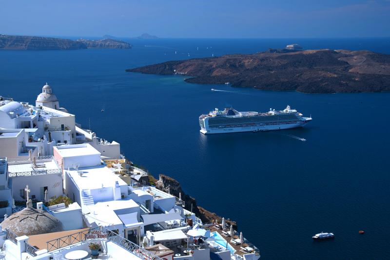 A cruise ship offers memorably fantastic views of the classic whitewashed villages of Santorini. Photo by Cameron Hewitt